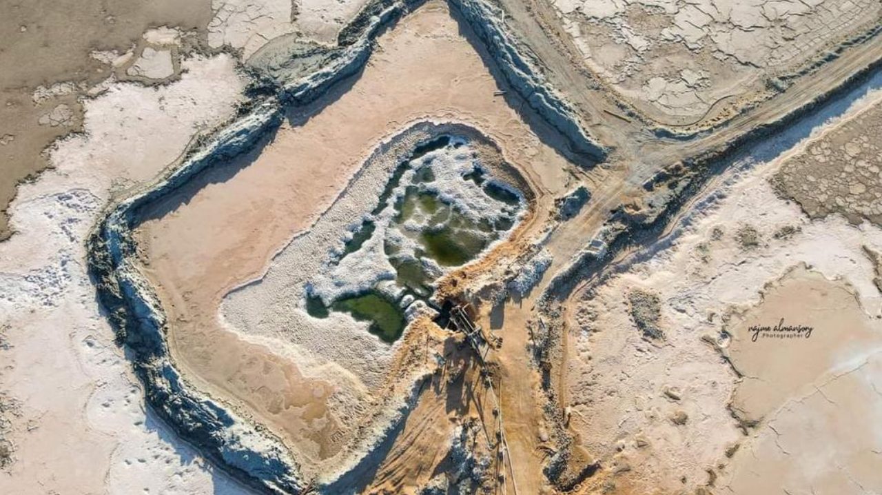 Drained crystalliser pond after harvest at the Al Mozan salt works, Ras Ajdir, Libya, with residual brine and the salt bed exposed