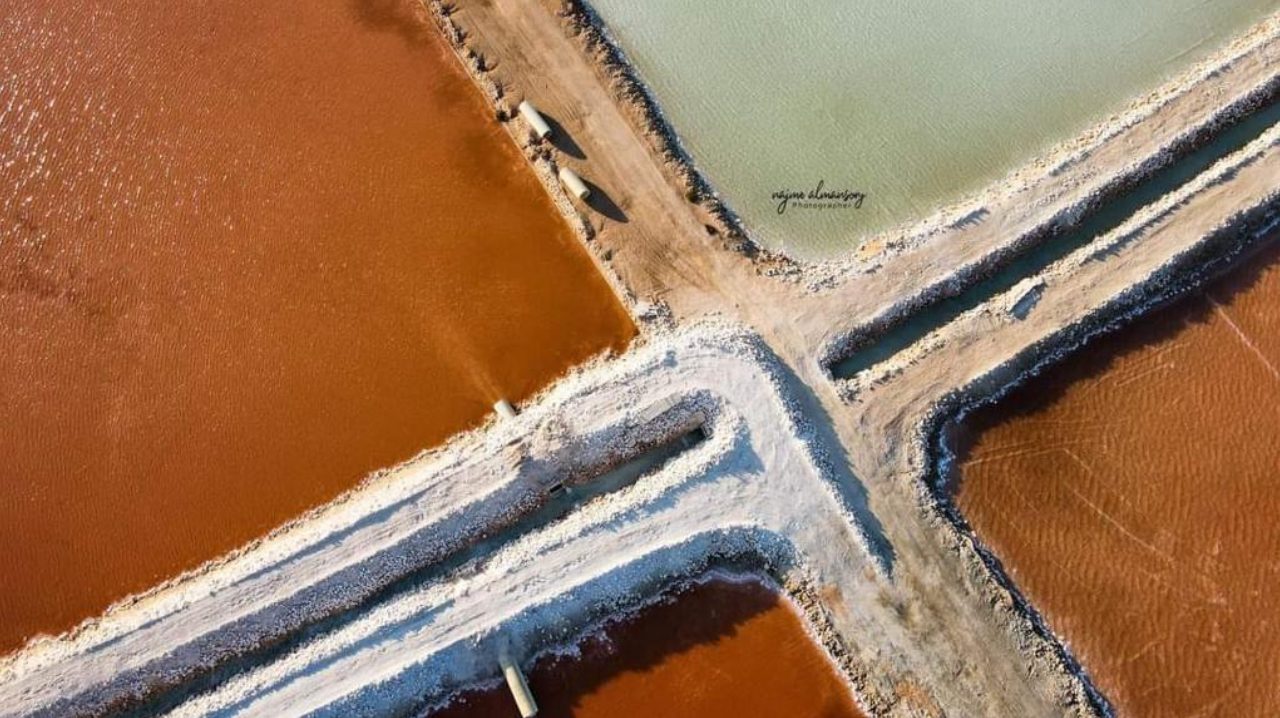 Close aerial view of pond levees and brine transfer pipes at the Al Mozan solar salt works, Libya
